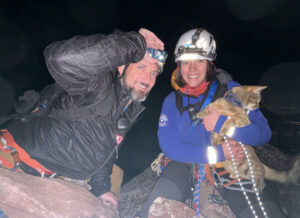 climbers at night holding a cat